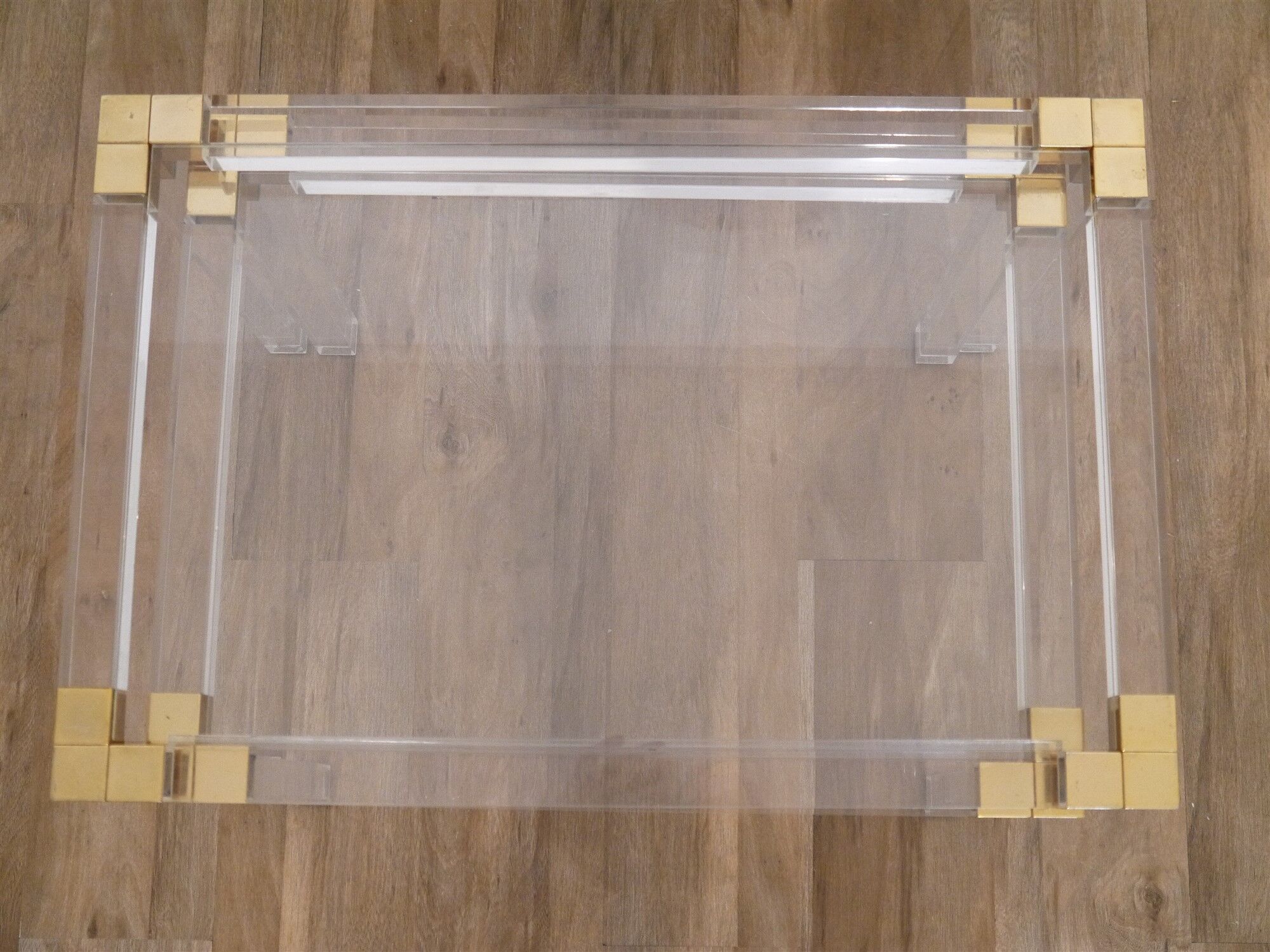 Nesting tables from the 1970s in brass, glass and lucite