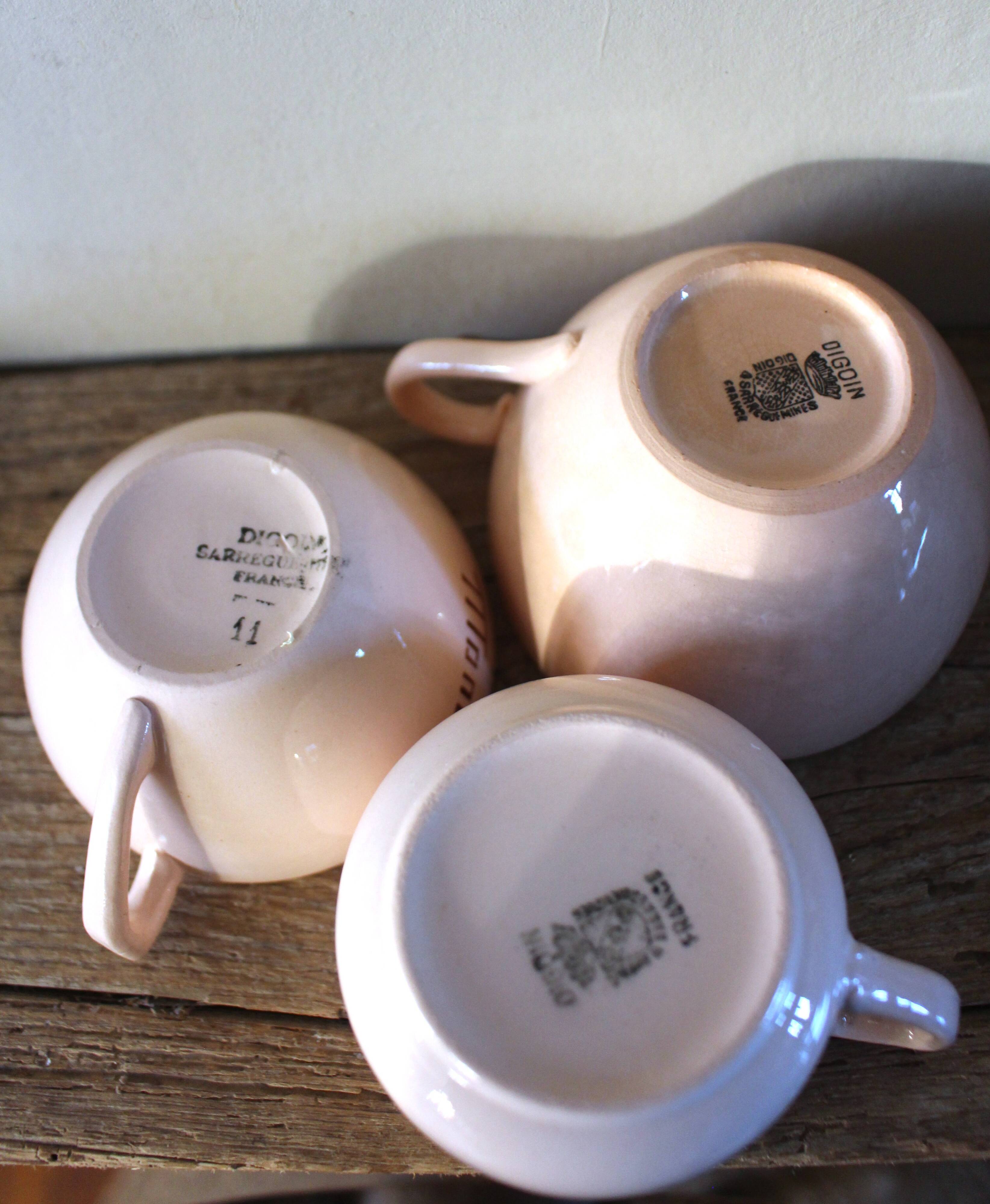 A set of 3 pink earthenware cups from Digoin Sarreguemines.