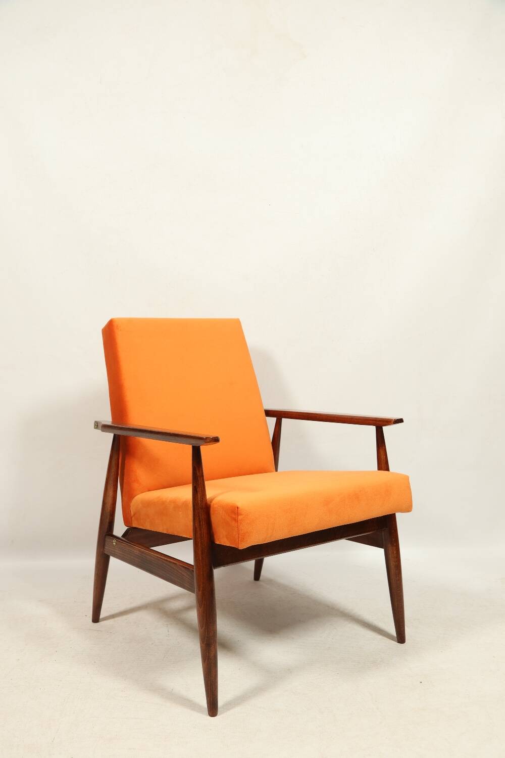 Modern armchair in orange papaya velvet with dark brown wood, 1970s Scandinavian style.