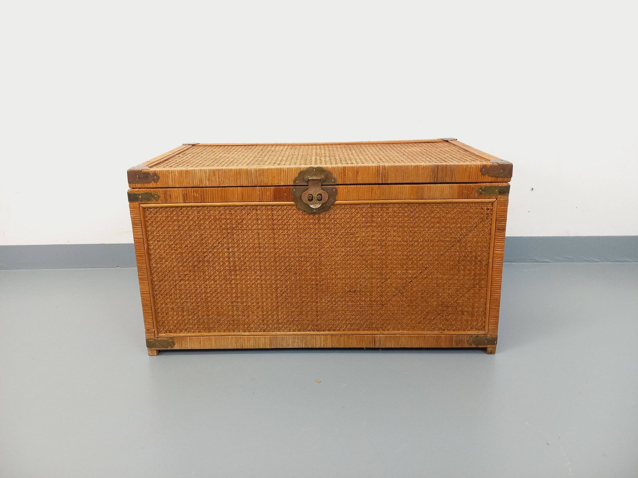 Vintage trunk in wood, rattan, caning, and brass.