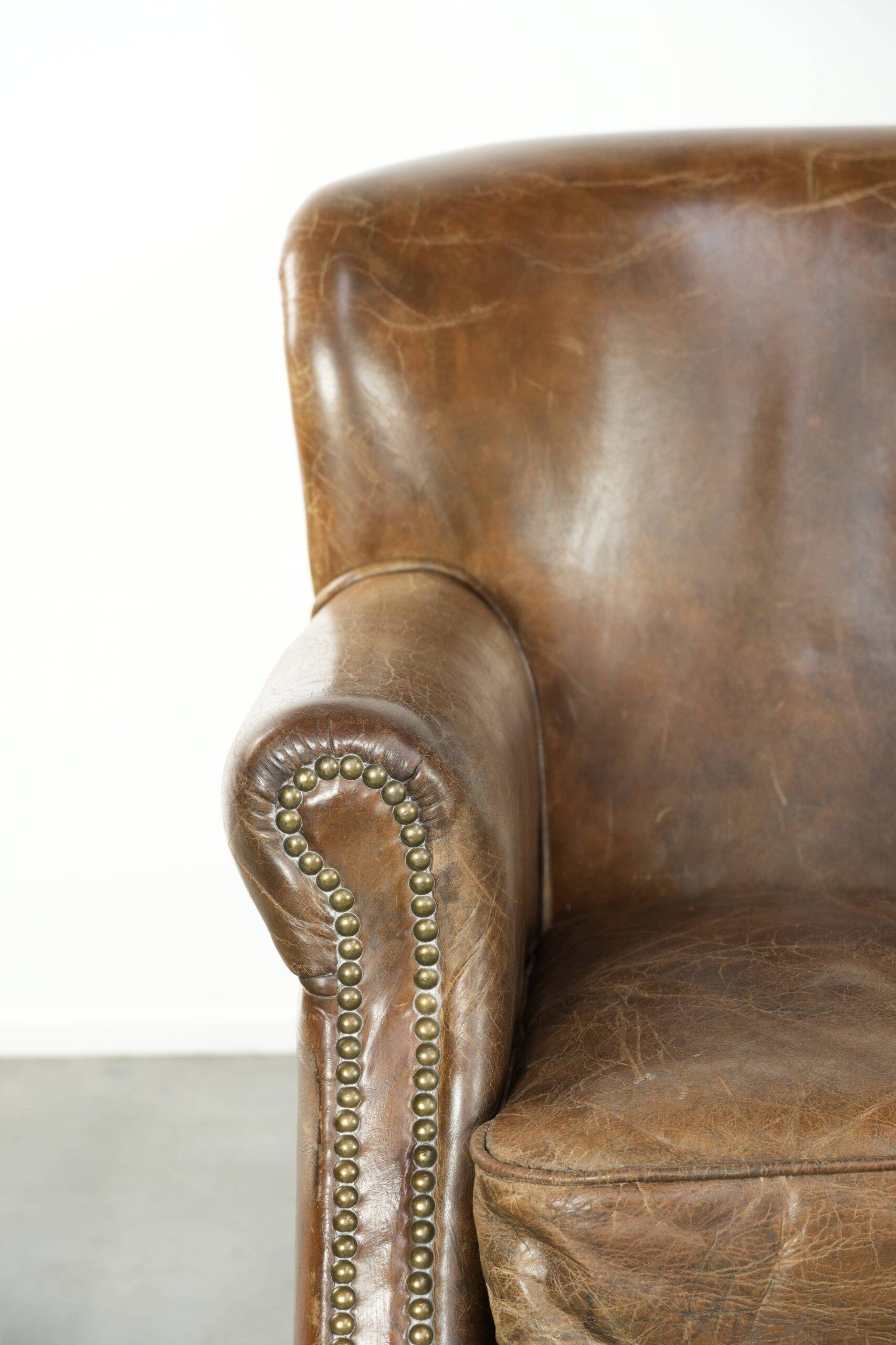 Robust cowhide armchair in a beautifully subtle size with a wonderful patina.