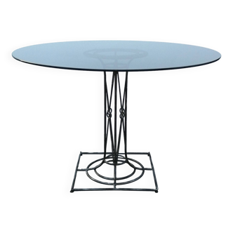 Wrought iron dining table with its round smoked glass top, vintage 1980