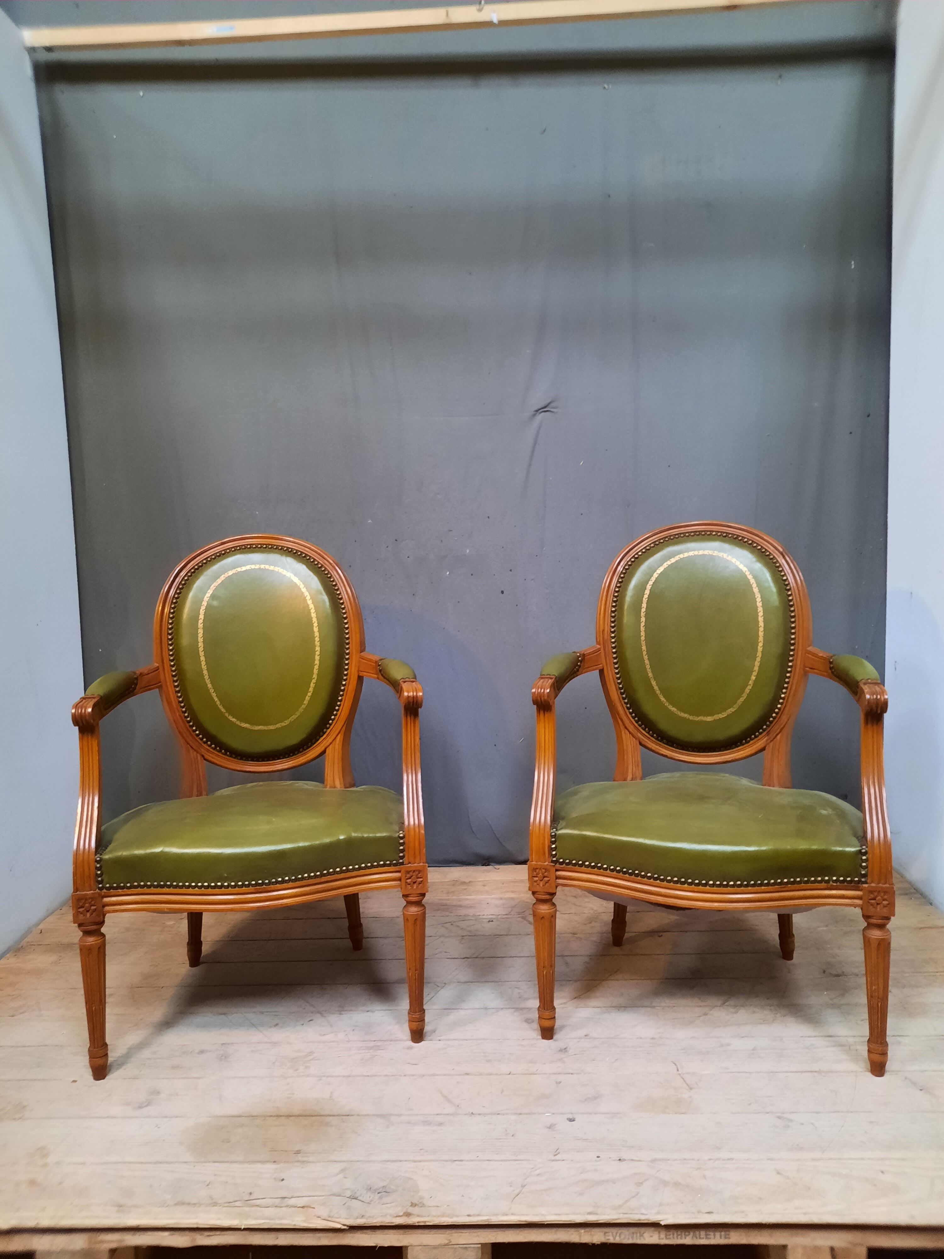 Pair of Louis XVI style leather armchairs