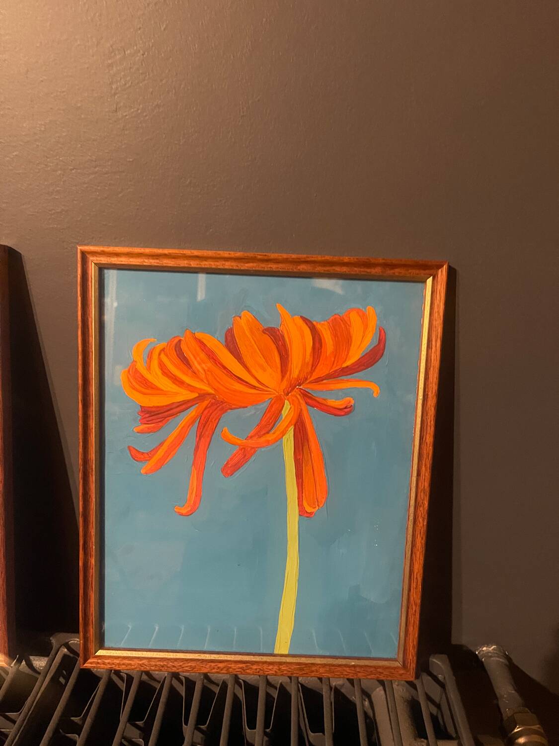 2 paintings of orange dahlias in antique wooden frames