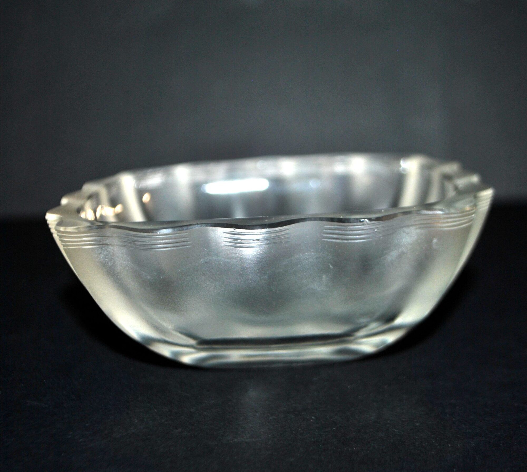 Lalique glass ashtray bowl with frosted finish, engraved with wave design, signed Lalique.