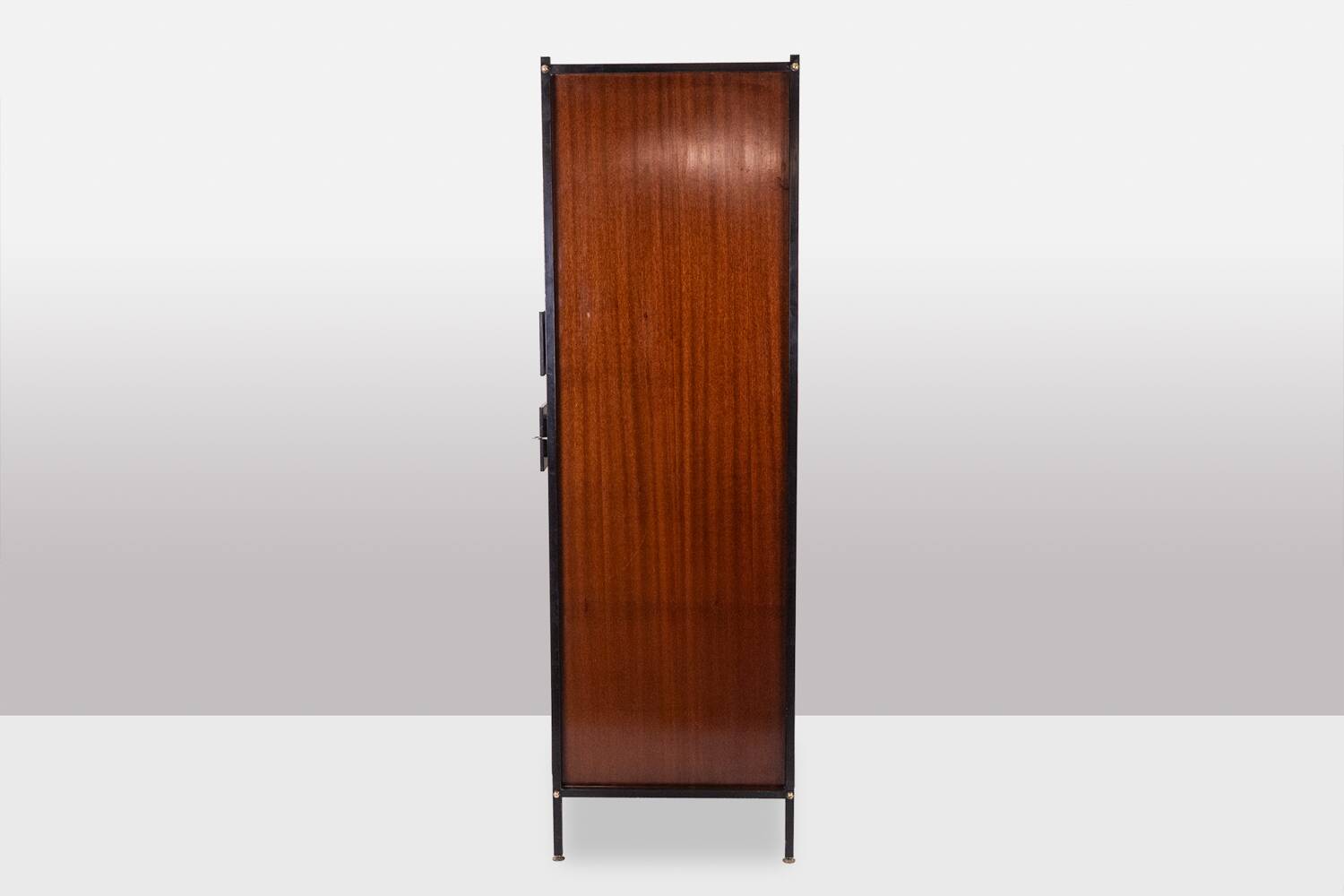 Pair of mahogany veneer and black lacquered iron cabinets. 1950s.