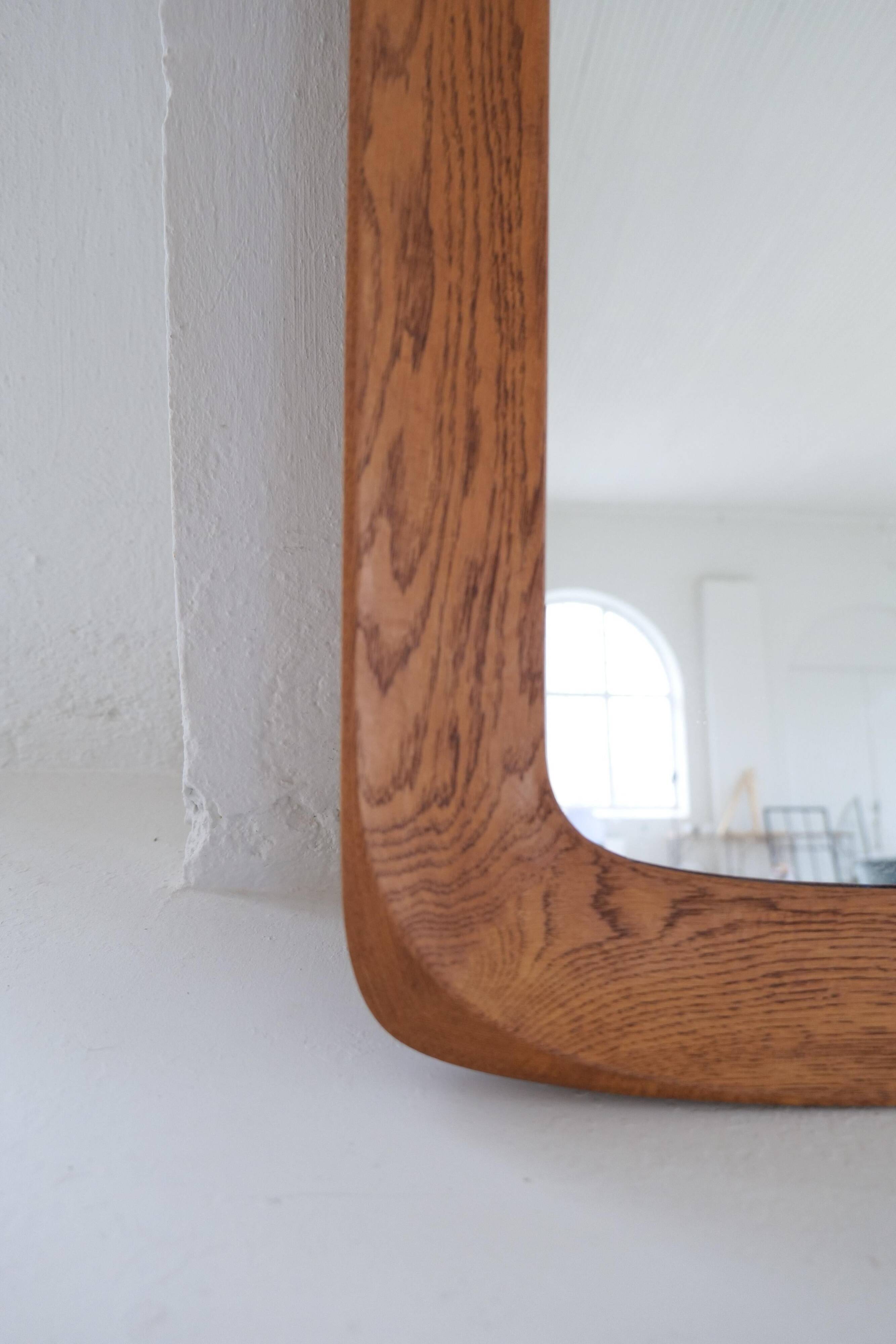 Mid-century modern sculptural wall mirror in stained oak, glass, Glas & Trä 1959