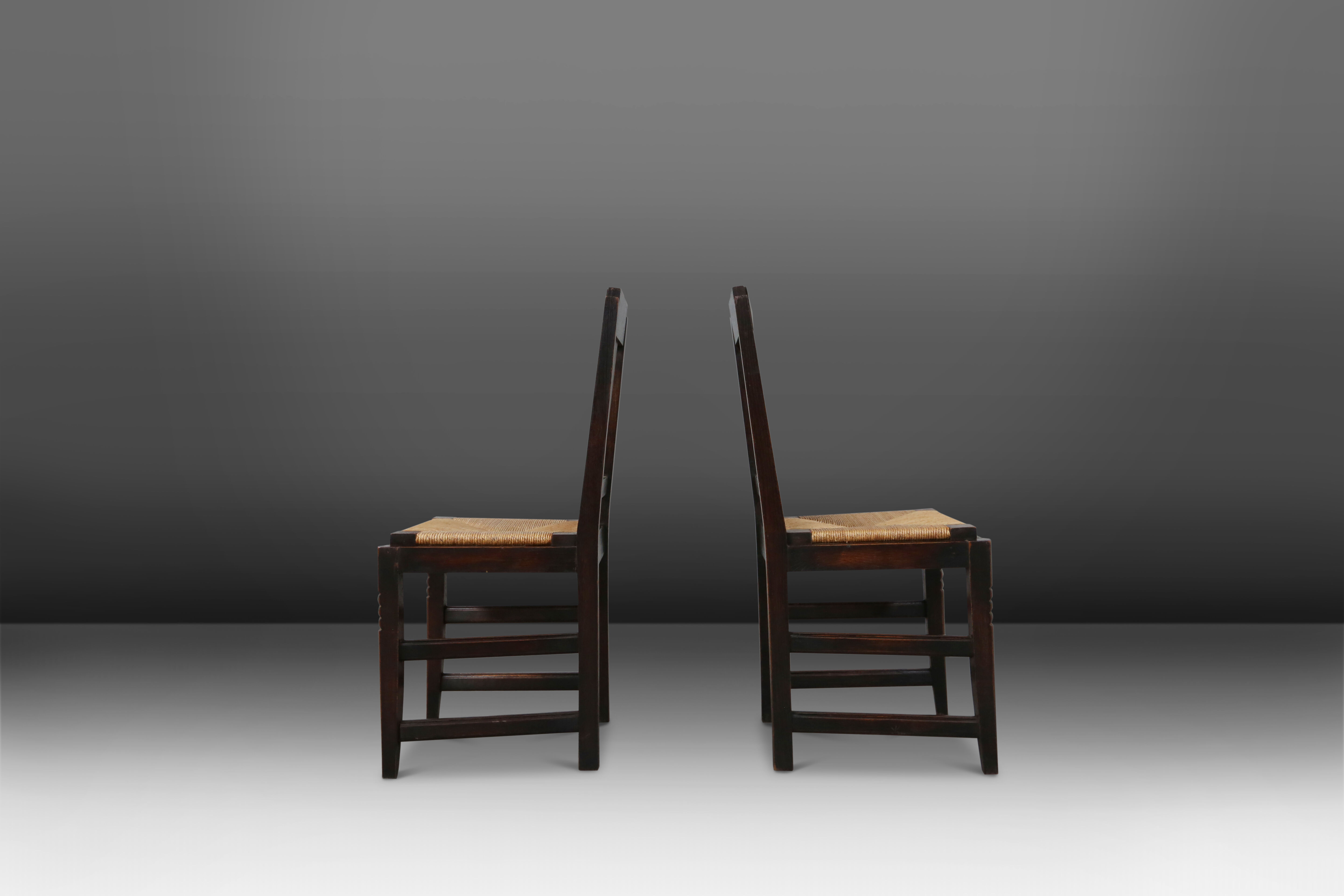 Set of six oak an wicker dining chairs by Victor Courtray