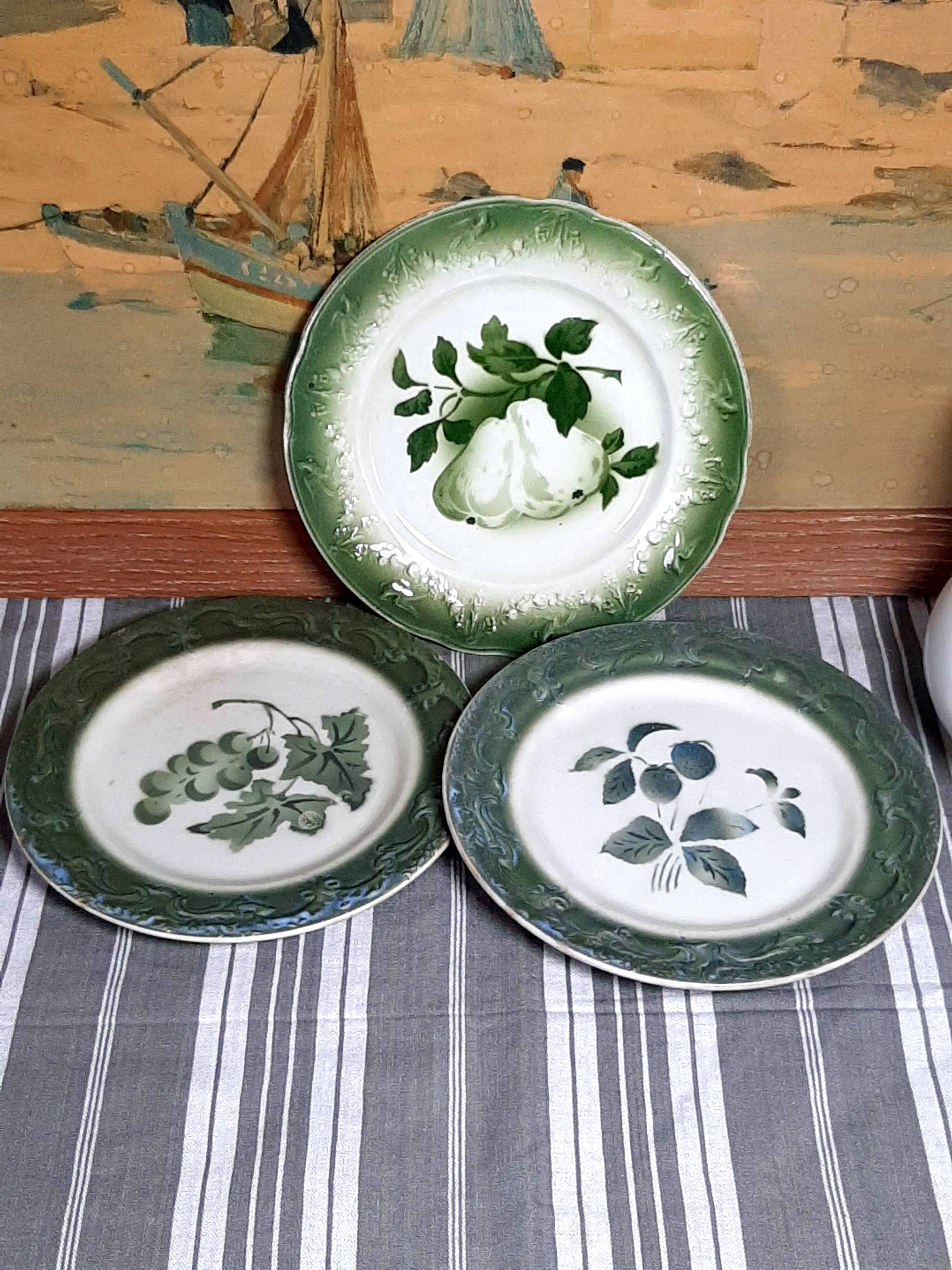 Antique earthenware plates with fruit decoration.