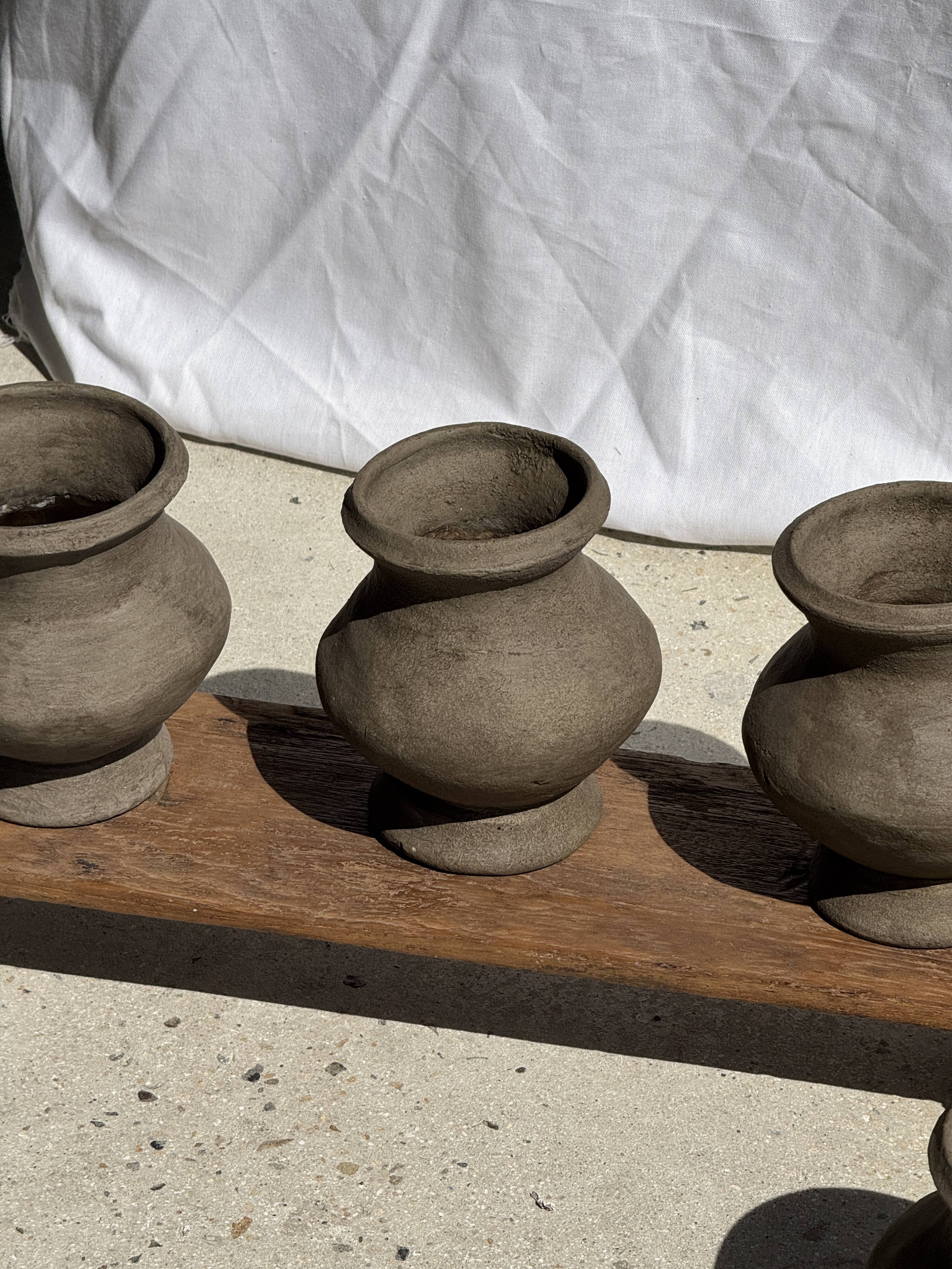 Small brutalist handcrafted terracotta vase with a pedestal, Indonesian, H19 D17.