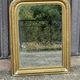 Louis Philippe mirror in gilded wood with an openwork frieze and mercury glass.