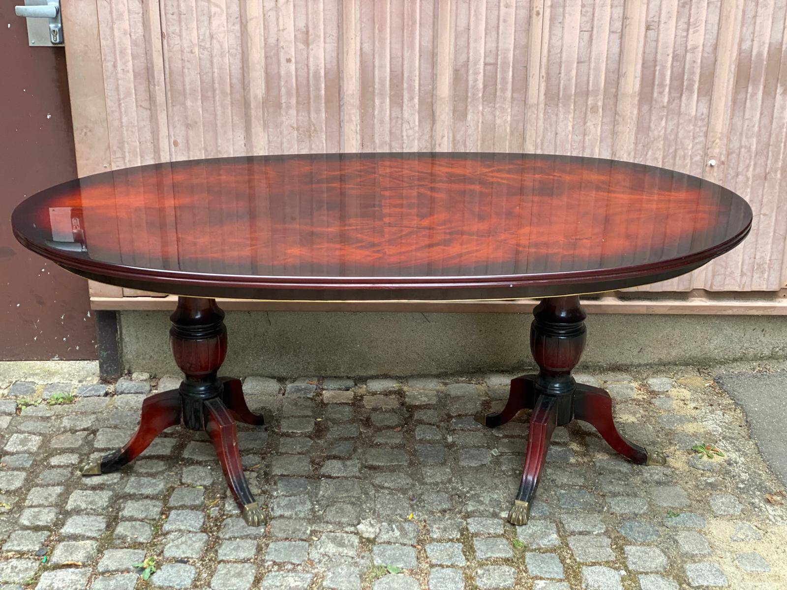 Glossy mahogany dining table in English Regency style from the 1970s.