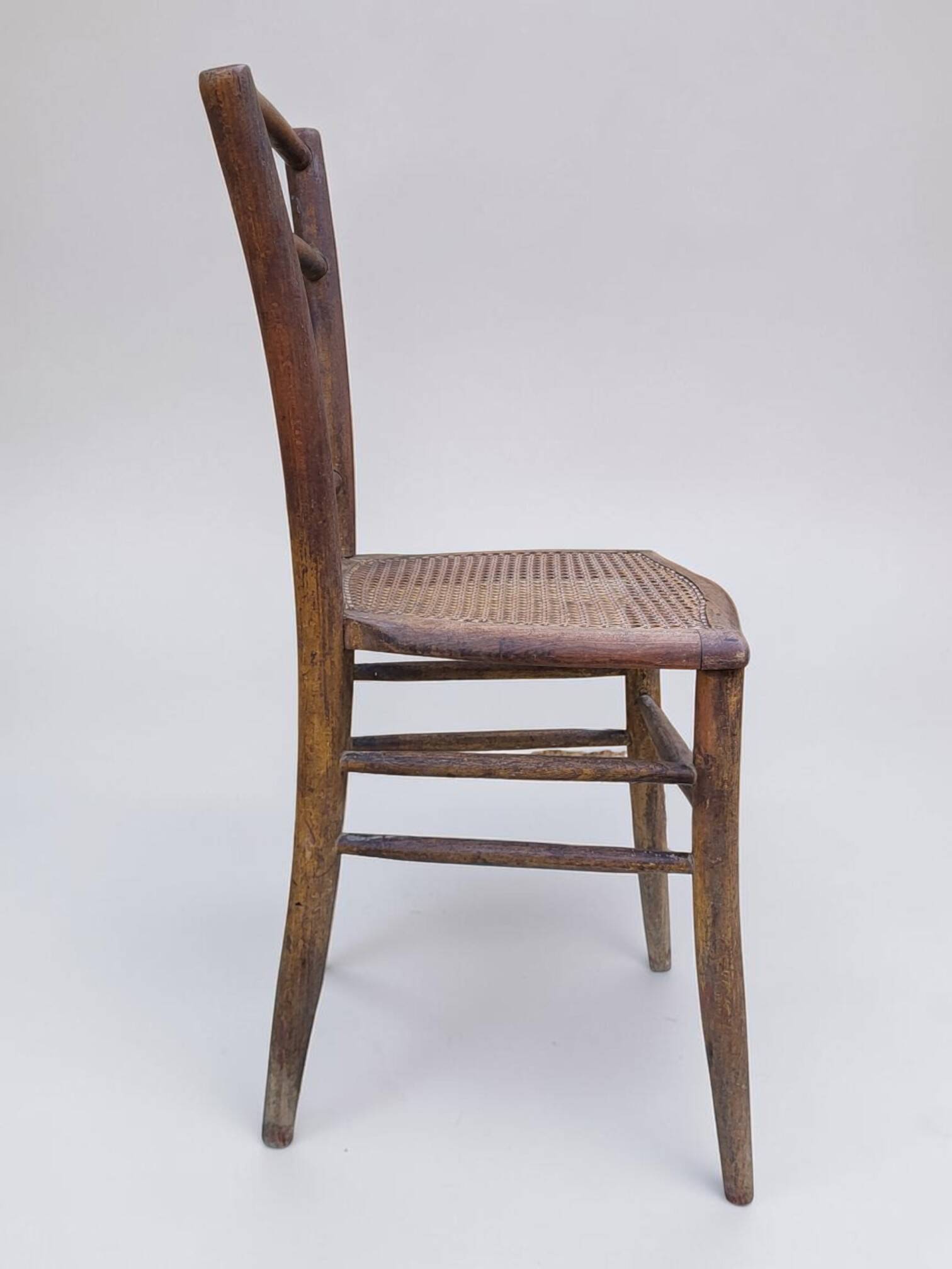 Chair with a slatted backrest and caned seat.