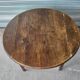 Antique round farmhouse table with drop-leaf doors in solid pegged wood
