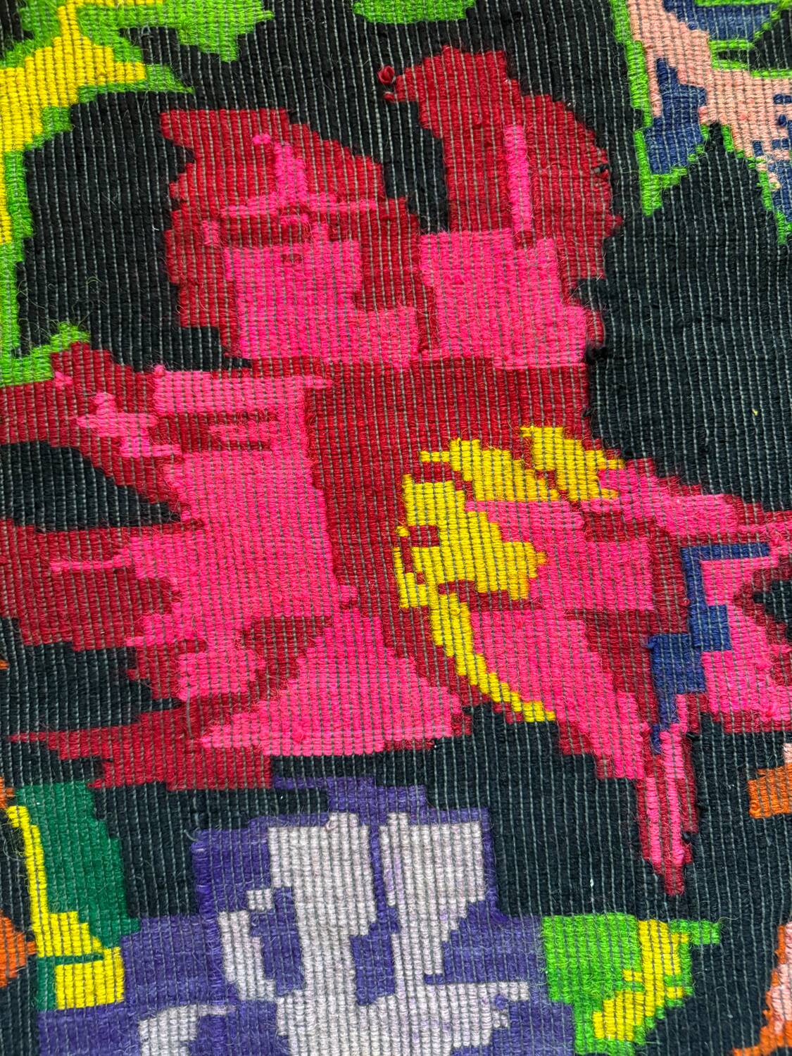 Bohemian floral design, handwoven wool rug, black background with colorful flowers