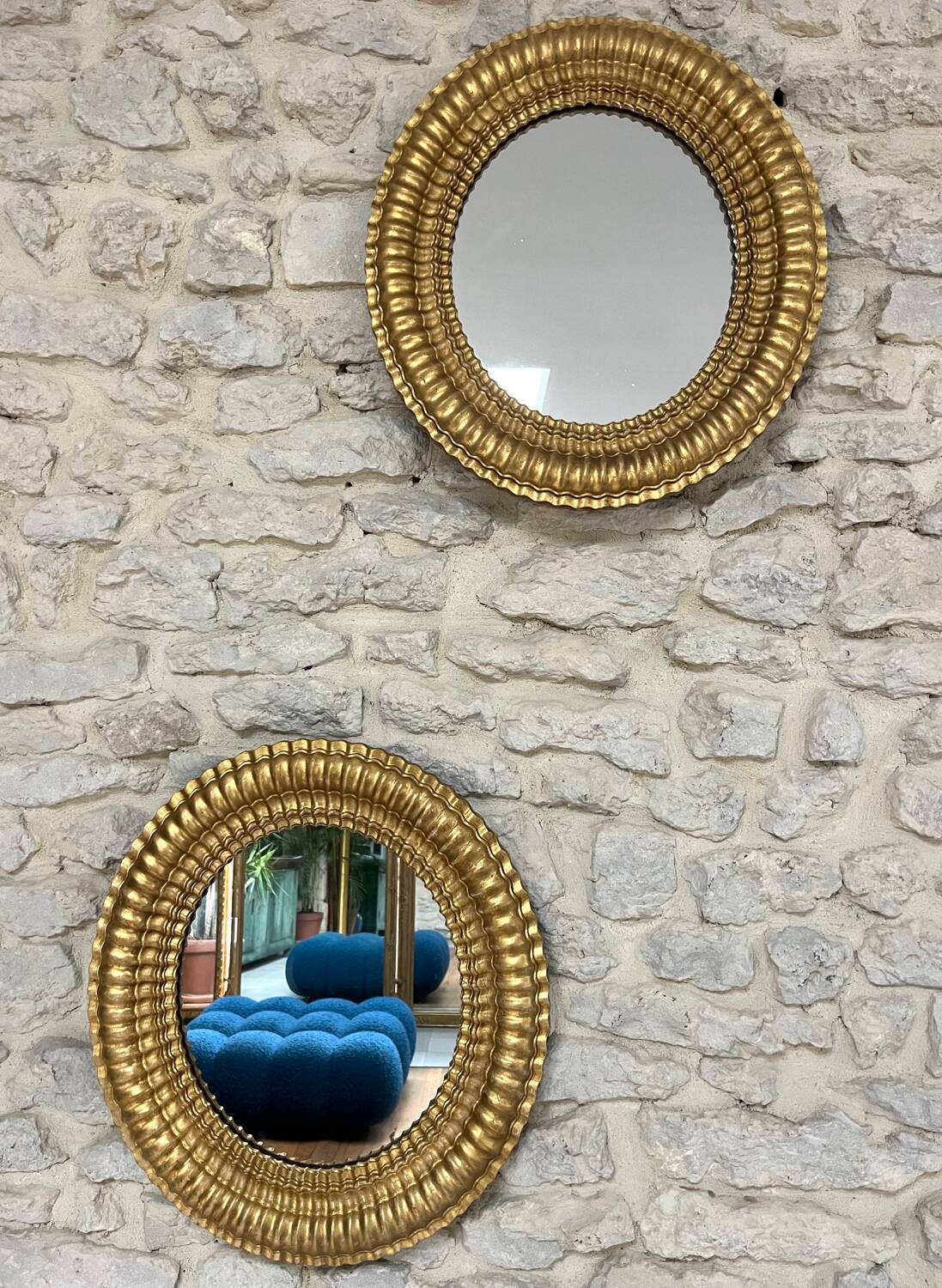 Pair of antique oval mirrors gilded with gold leaf and mercury.