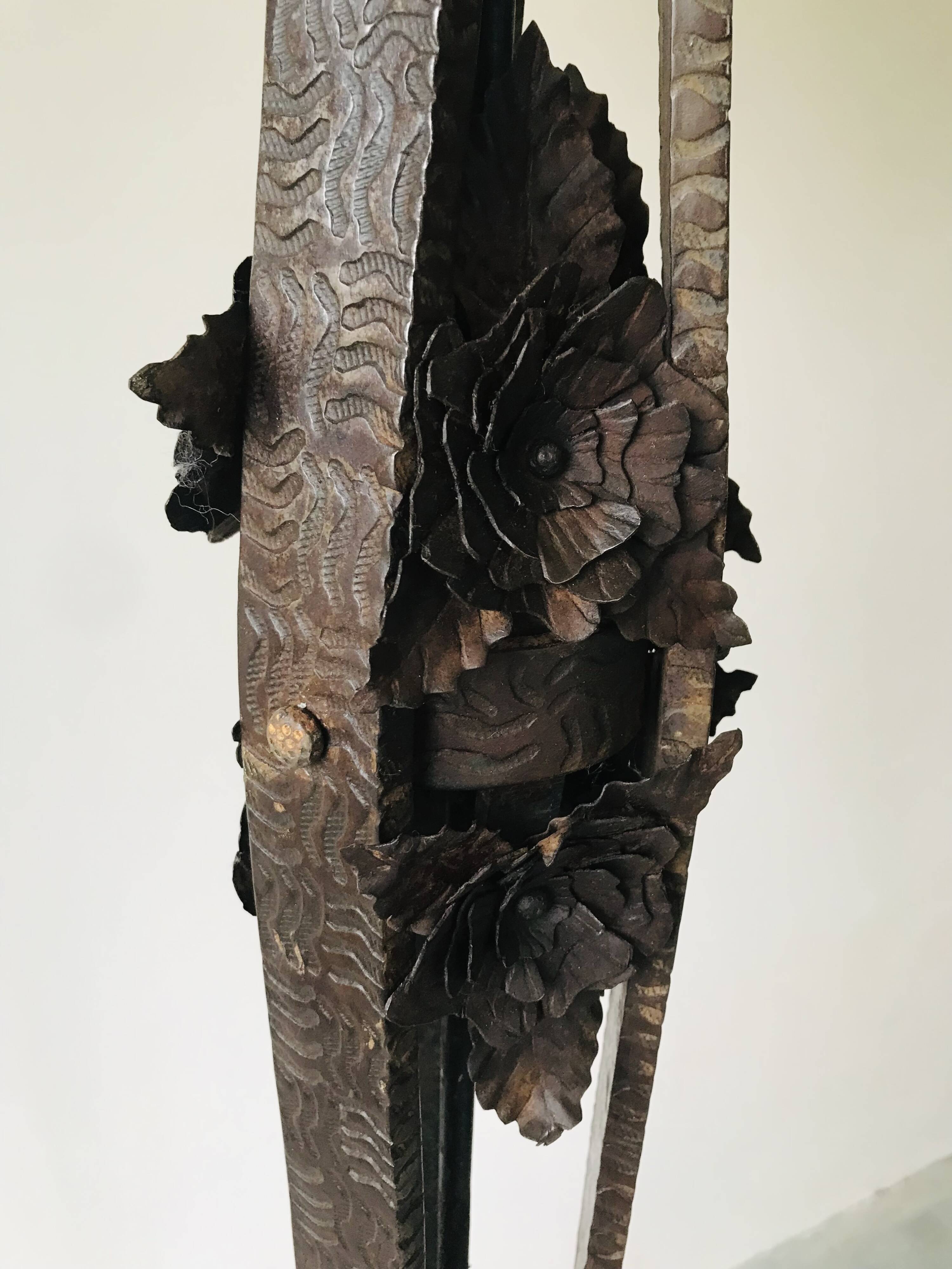 Art deco wrought iron floor lamp decorated with flowers, circa 1930.