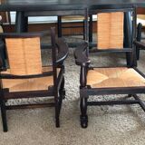 Pair of vintage 1950s Neo-Basque oak armchairs with straw seats and backs.