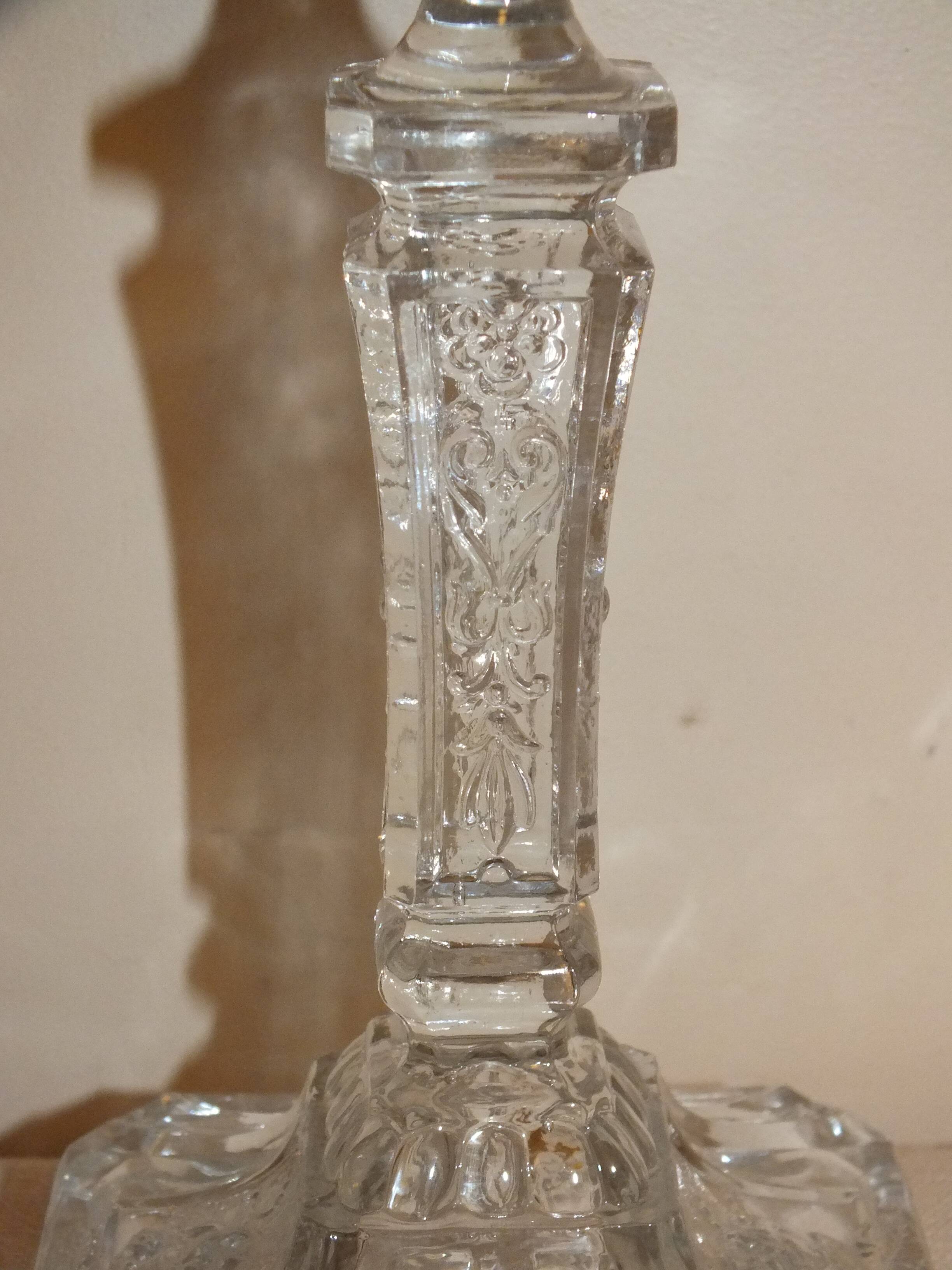 19th century candlestick in molded glass decorated with roses and lions
