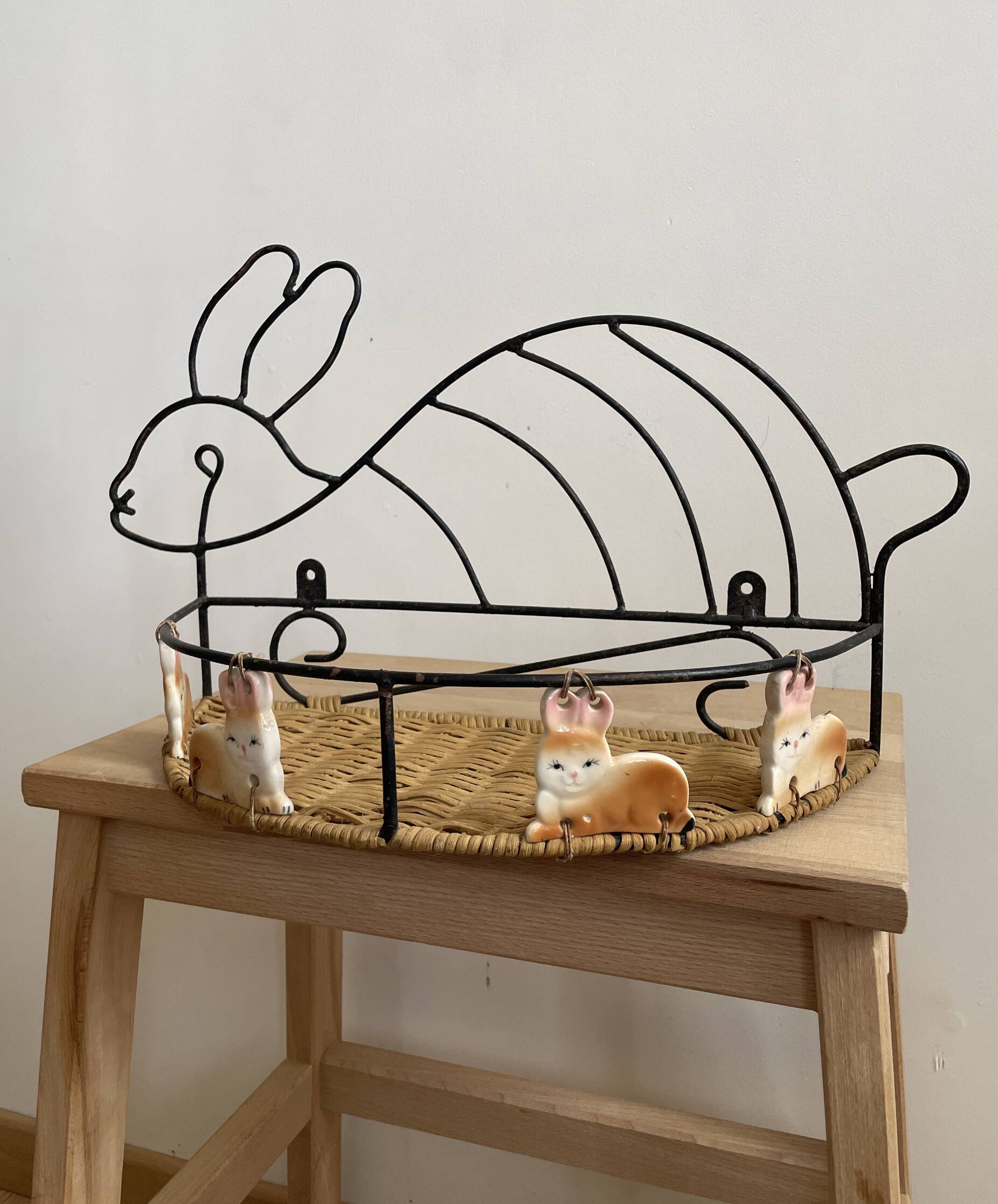 Wrought iron shelf and porcelain rabbit figurines