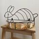 Wrought iron shelf and porcelain rabbit figurines