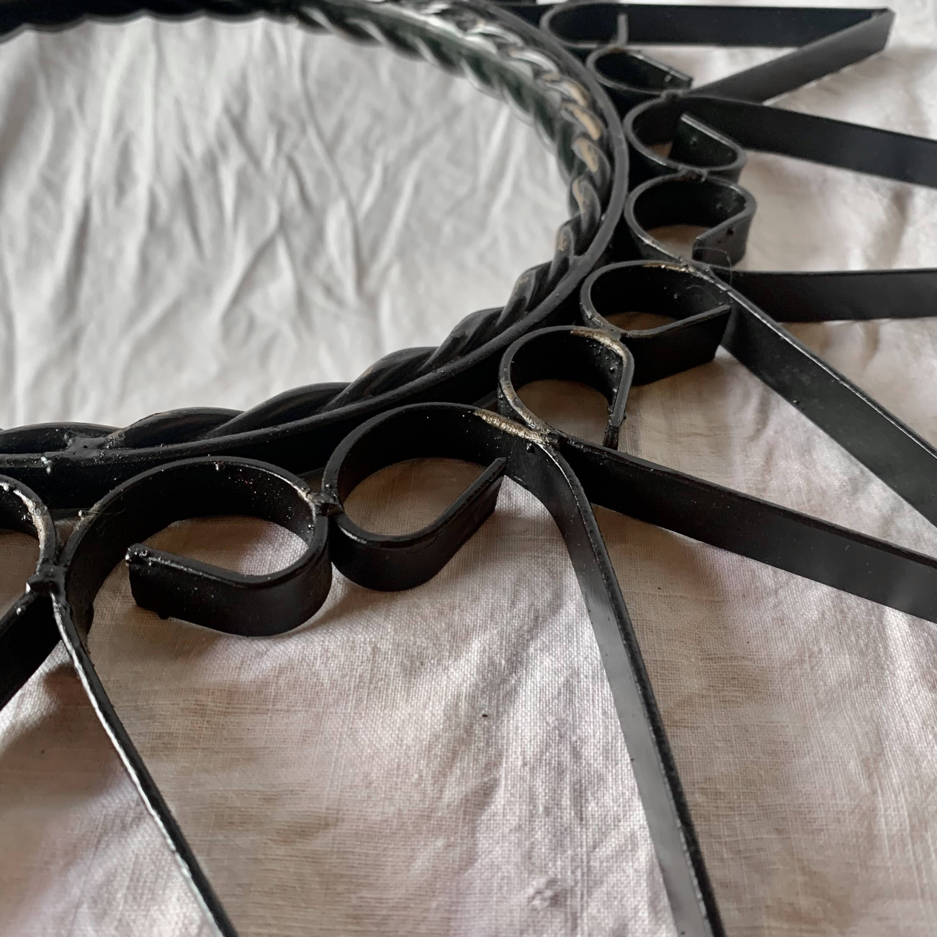 Old wrought metal sun mirror