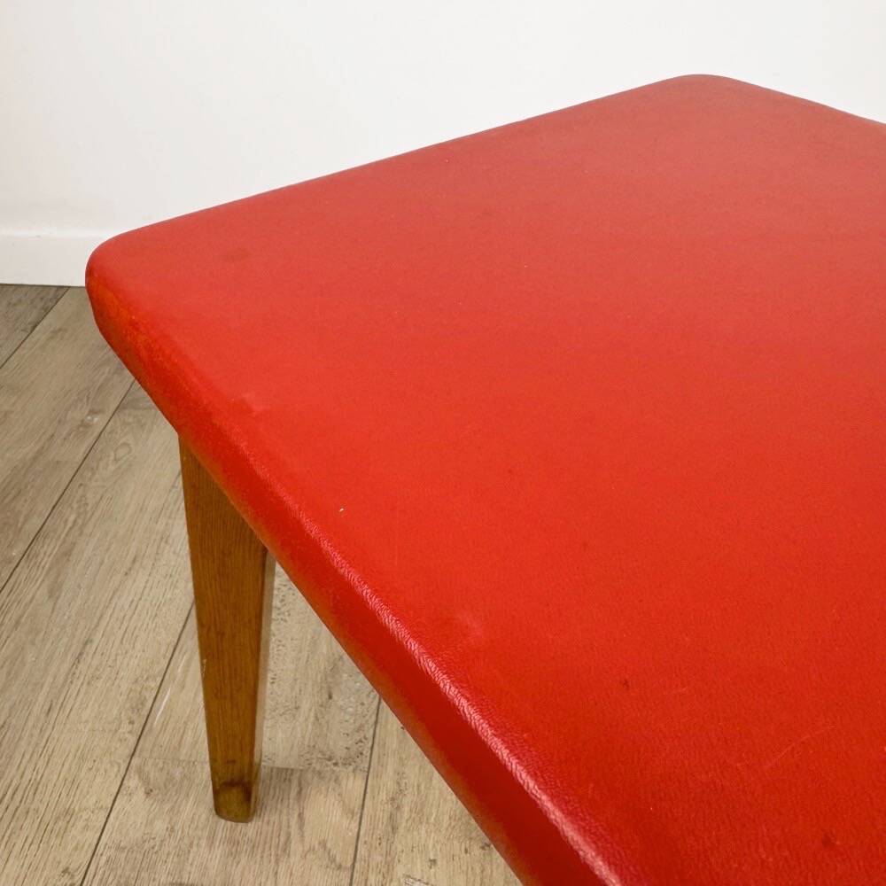 Wooden stool with red faux leather from the 1950s.