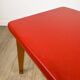Wooden stool with red faux leather from the 1950s.