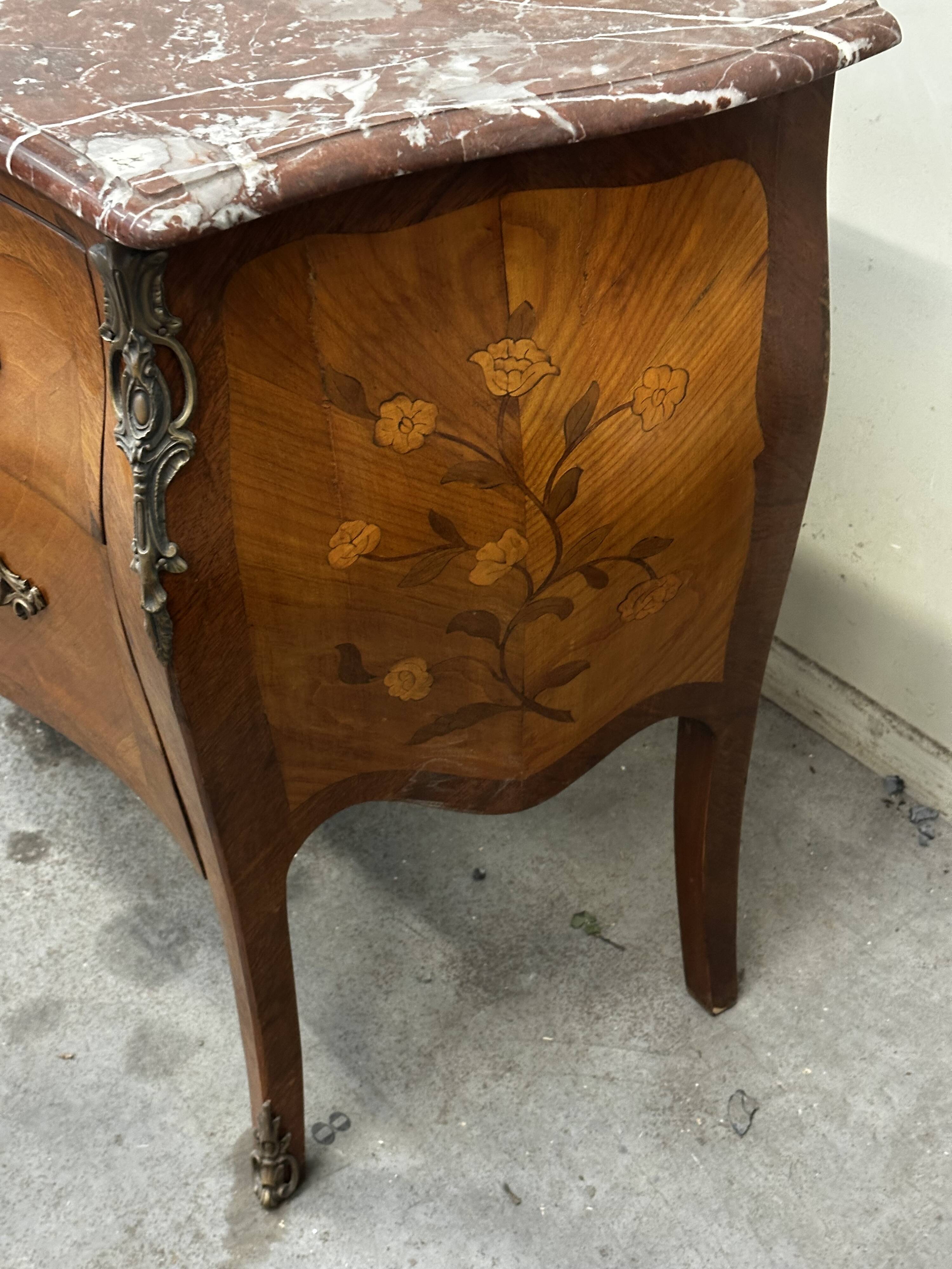 Curved and inlaid Louis XV style chest of drawers