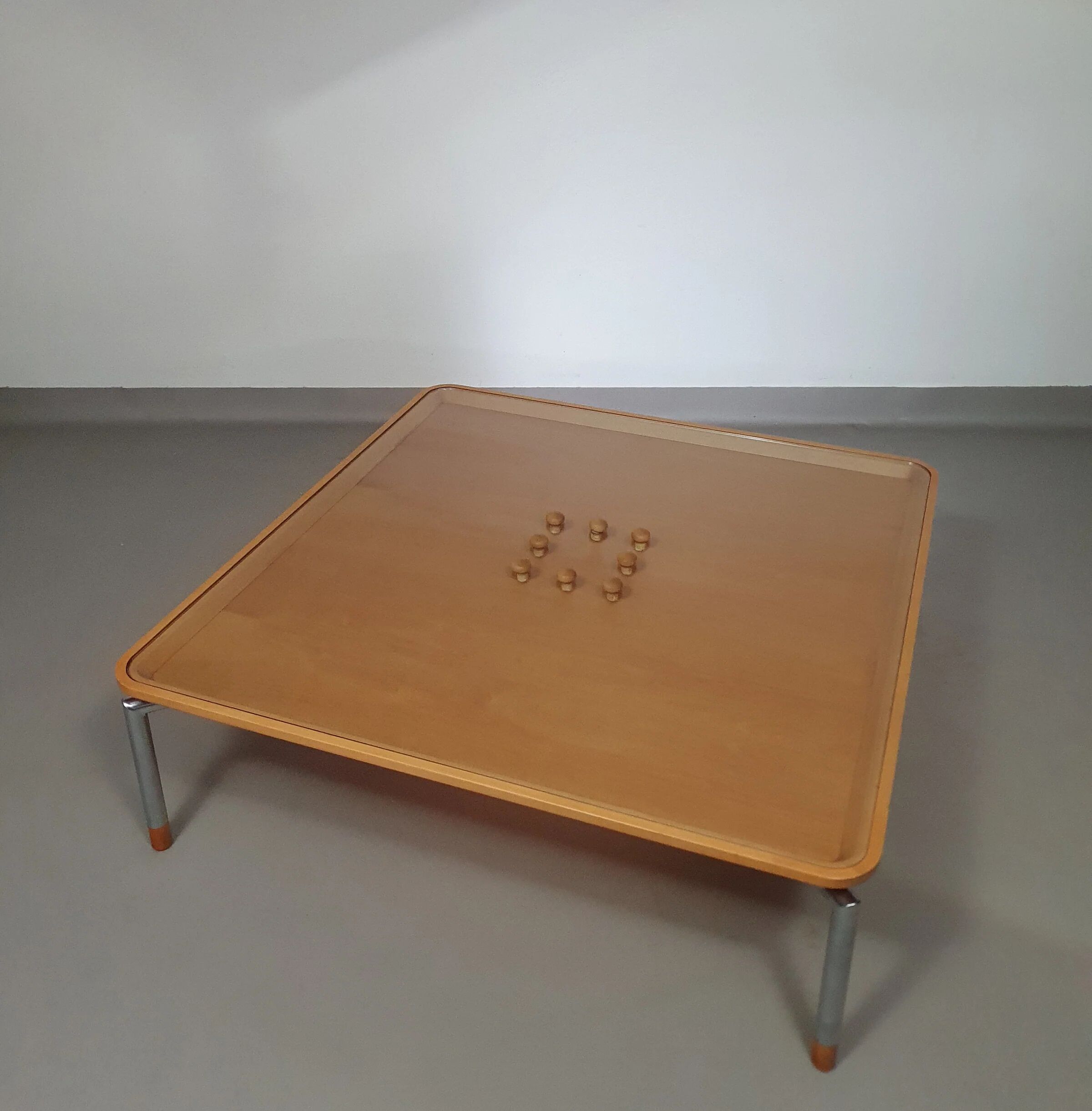 Rare coffee table 110 x 110 x height 35 cm with 8 flange wooden / cork caps in the glass top.