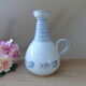 Vintage blue ceramic jug with hand-painted floral decoration.