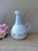 Vintage blue ceramic jug with hand-painted floral decoration.