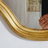 Free form mirror in golden wood