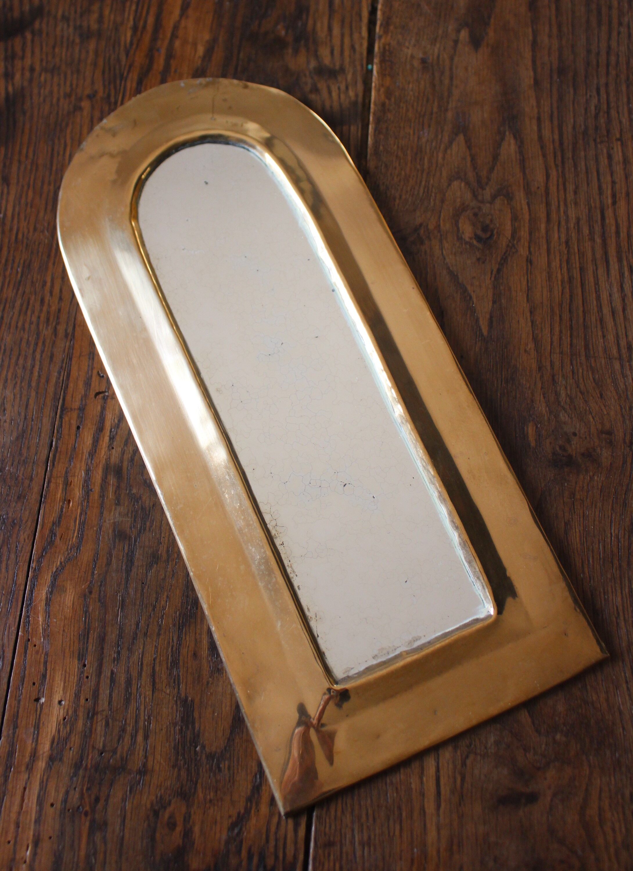 Rounded brass mirror