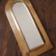 Rounded brass mirror