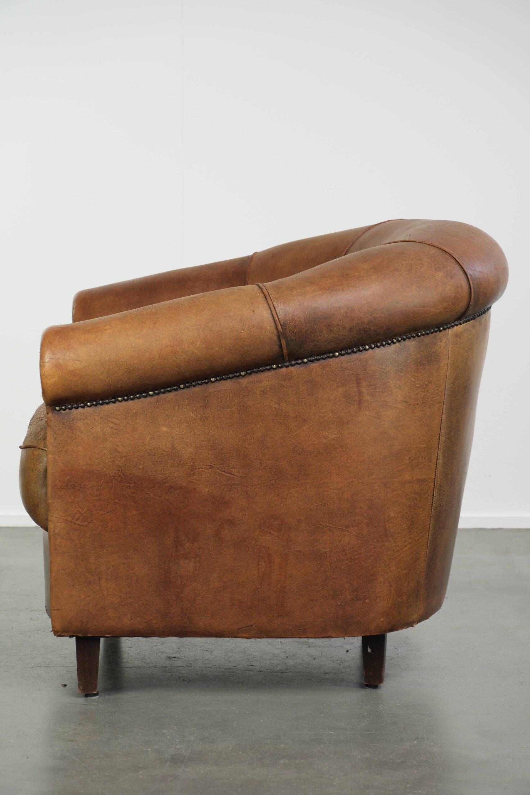 Aged sheepskin clubchair with beautiful vintage patina and comfortable seat