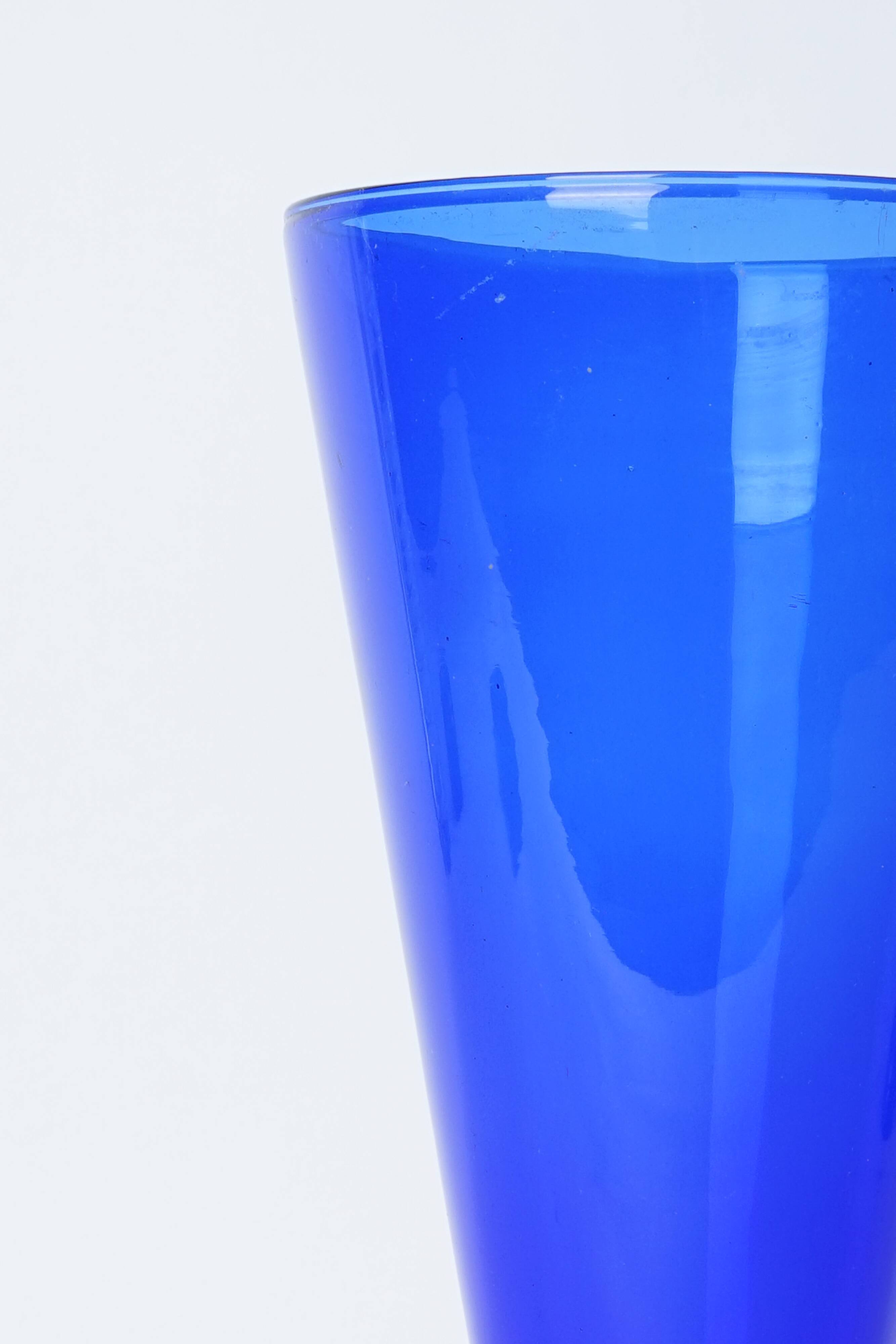Blue glass vase with green foot