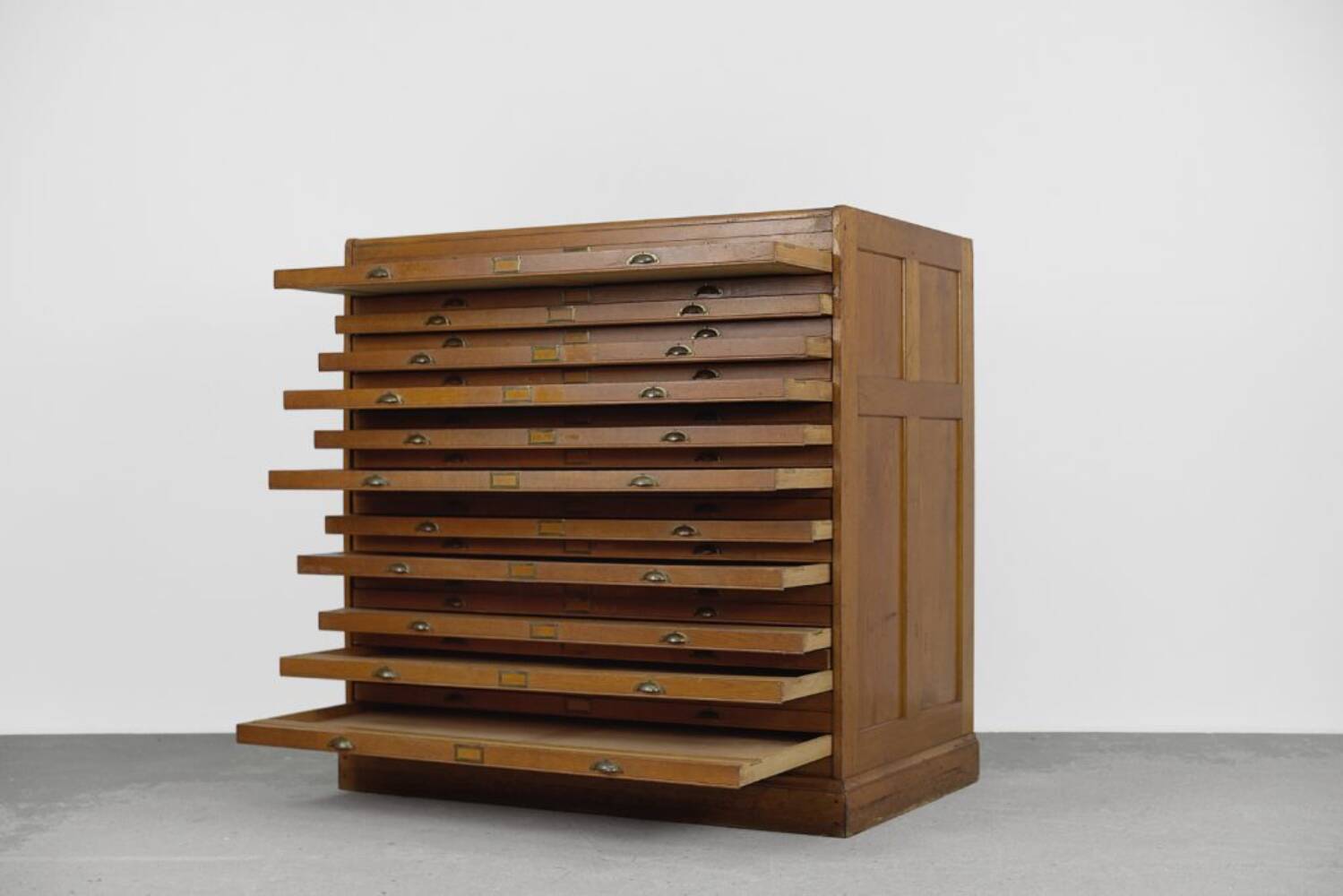Vintage industrial oak filing cabinet with several drawers, 1930s.