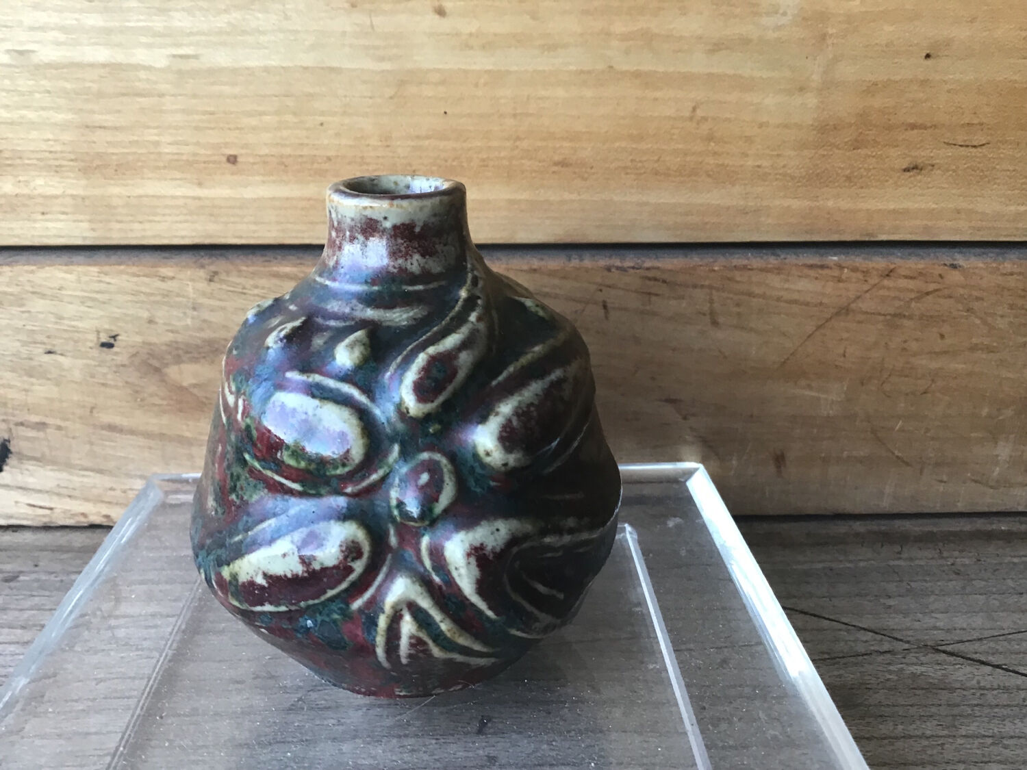 Small Dalpayrat vase shaped ball in polychrome glacured ceramic with relief decoration of a flower signed under the base