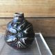 Small Dalpayrat vase shaped ball in polychrome glacured ceramic with relief decoration of a flower signed under the base