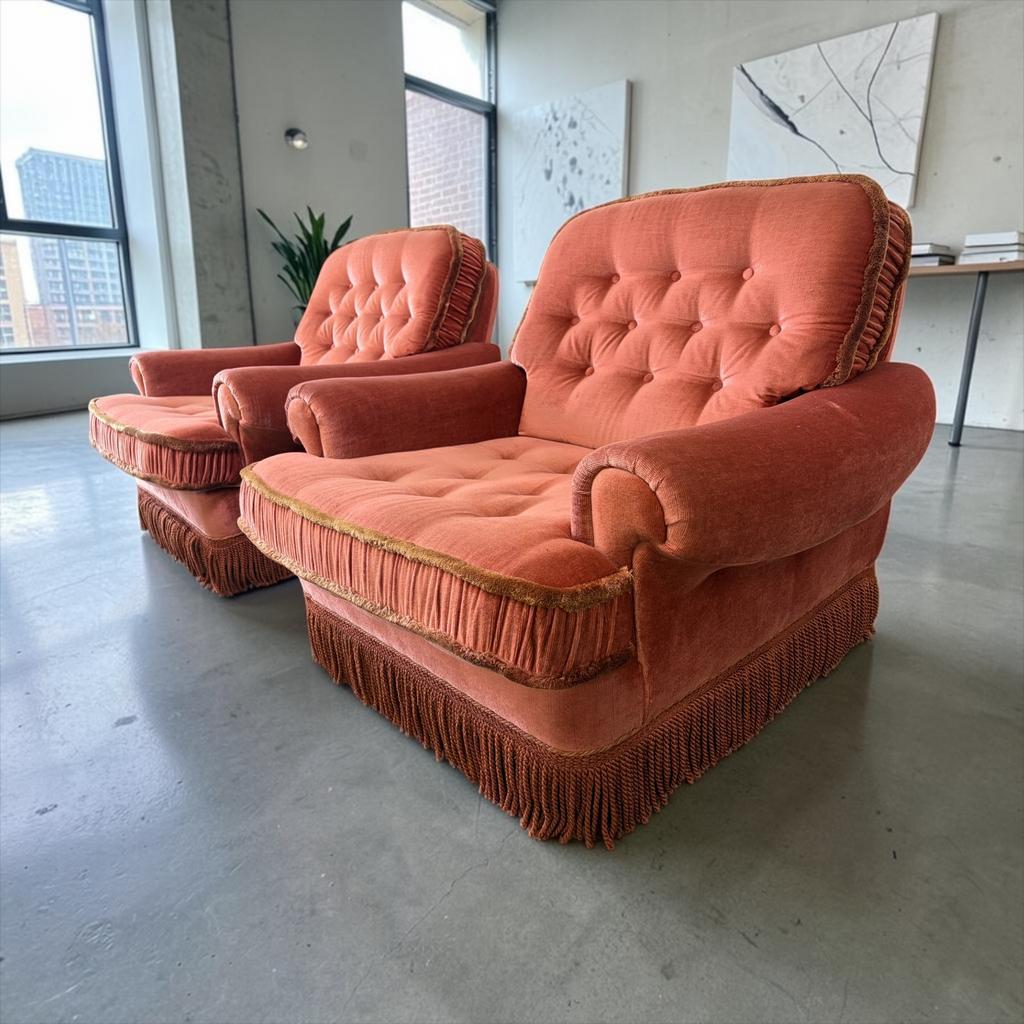 Set of 2 vintage old rose armchairs with fringes.
