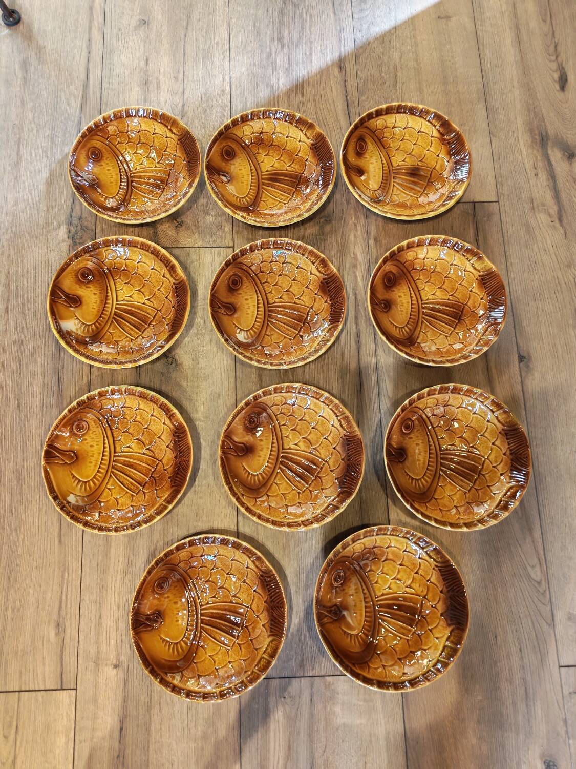 Vintage barbotine plates with fish decoration, 22 pieces.