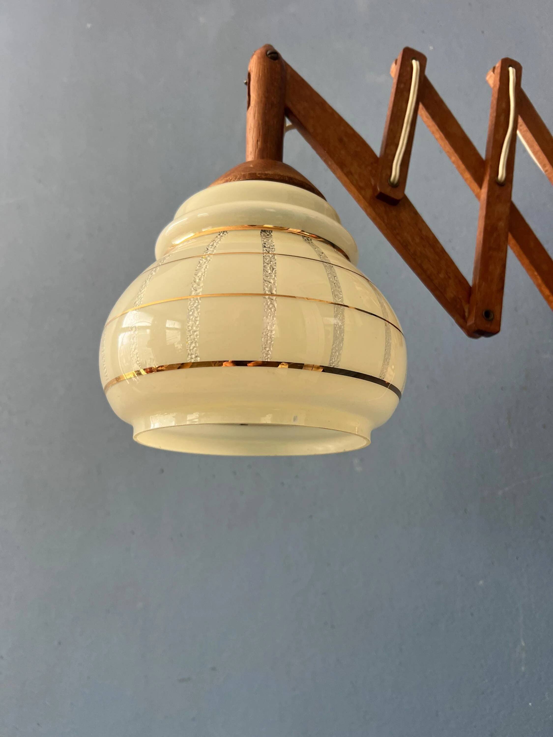 Vintage wall lamp with teak wood scissors and glass shade.