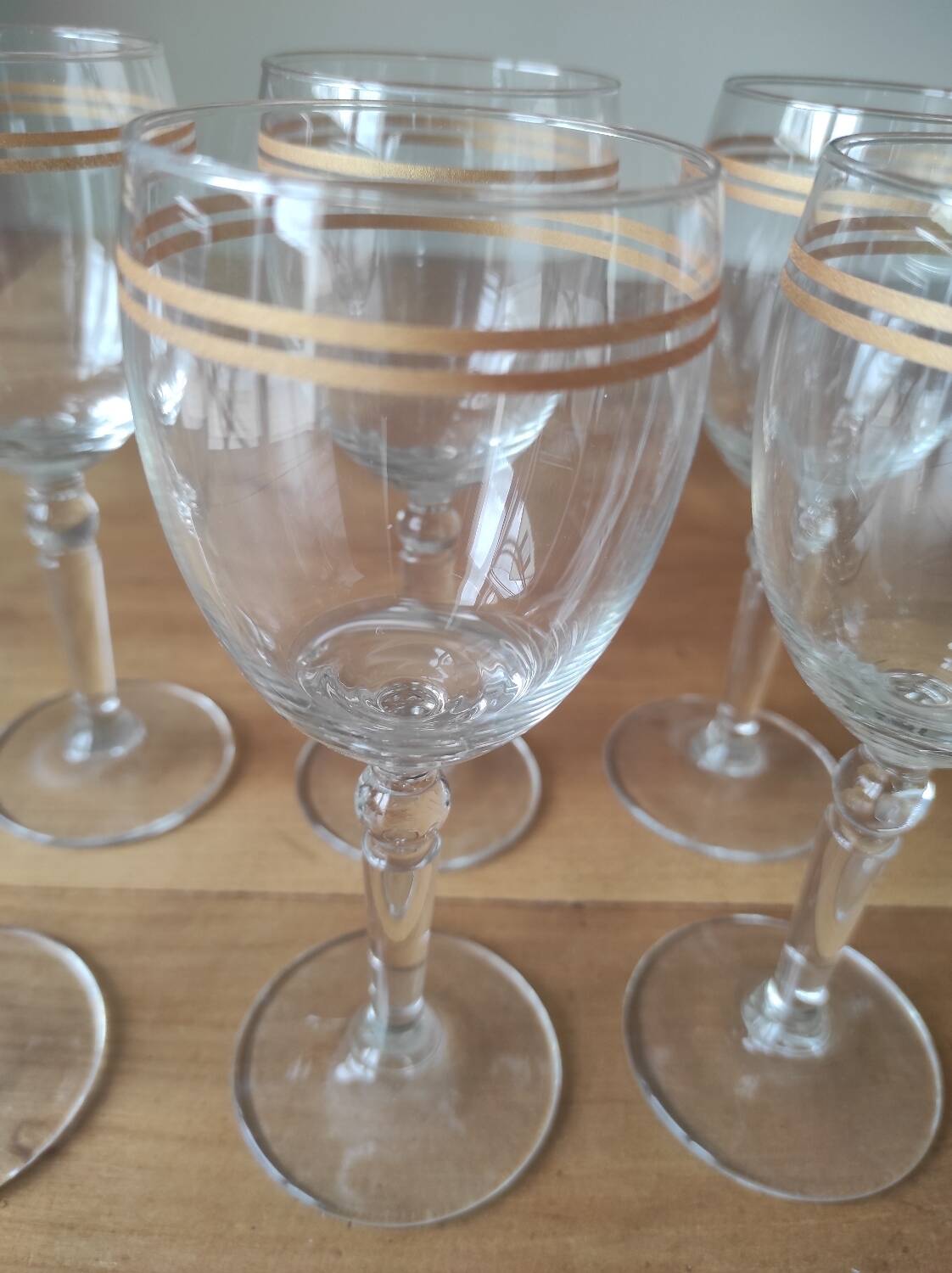 Set of 6 glasses with gold band decorations.