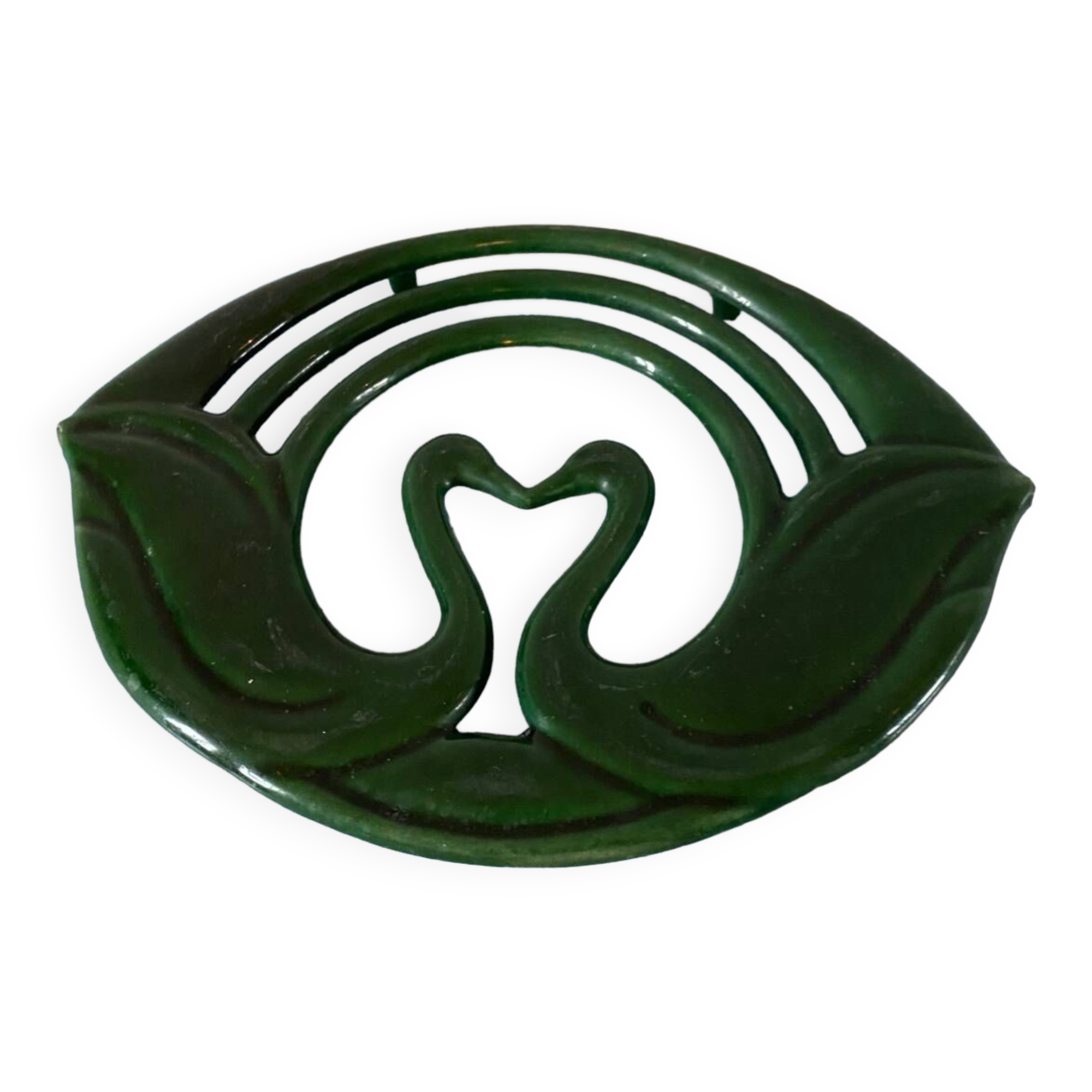 Enamelled cast iron trivet with sign decoration.