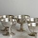 6 dessert bowls on a shiny metal stand.