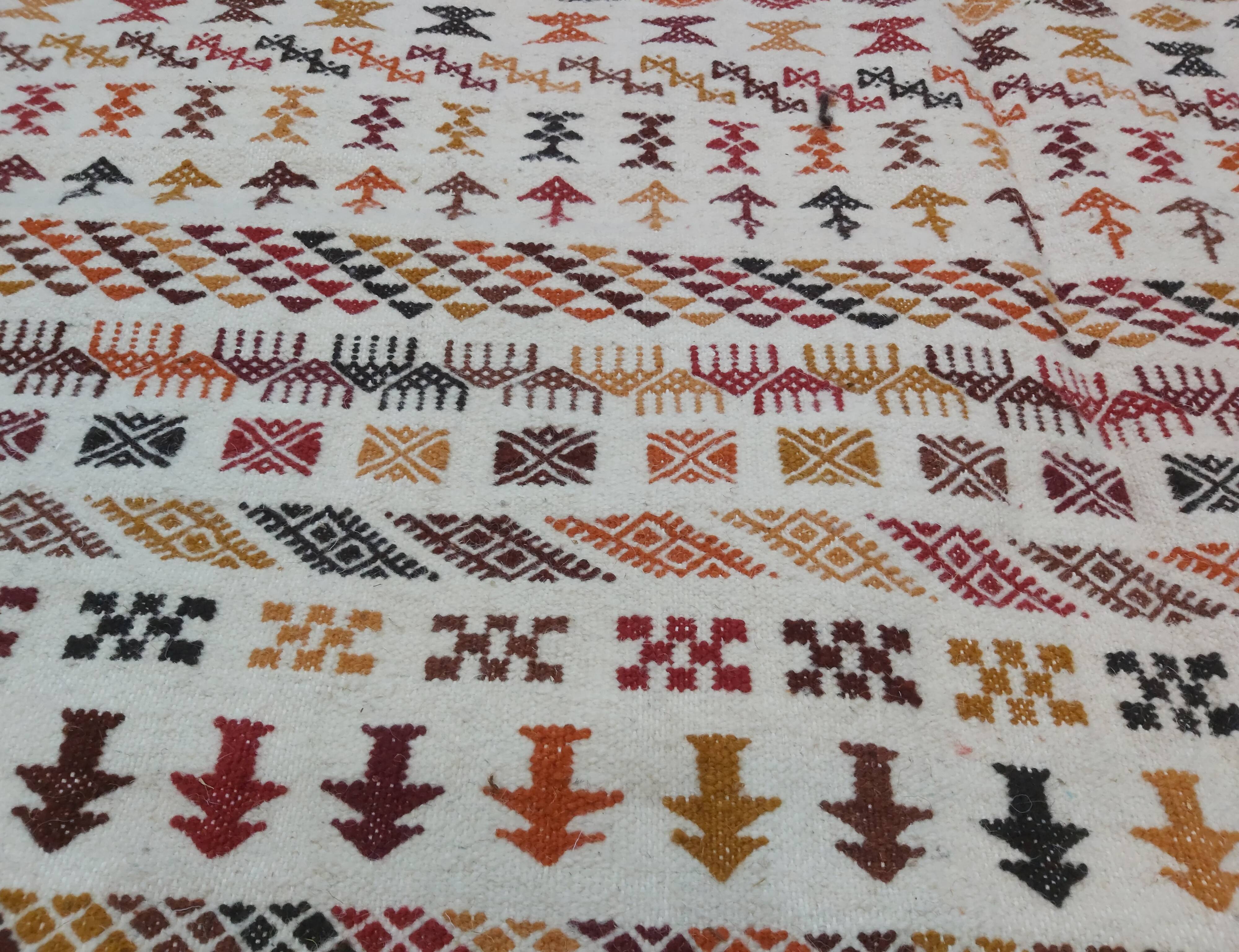 White carpet with multicolored Berber patterns