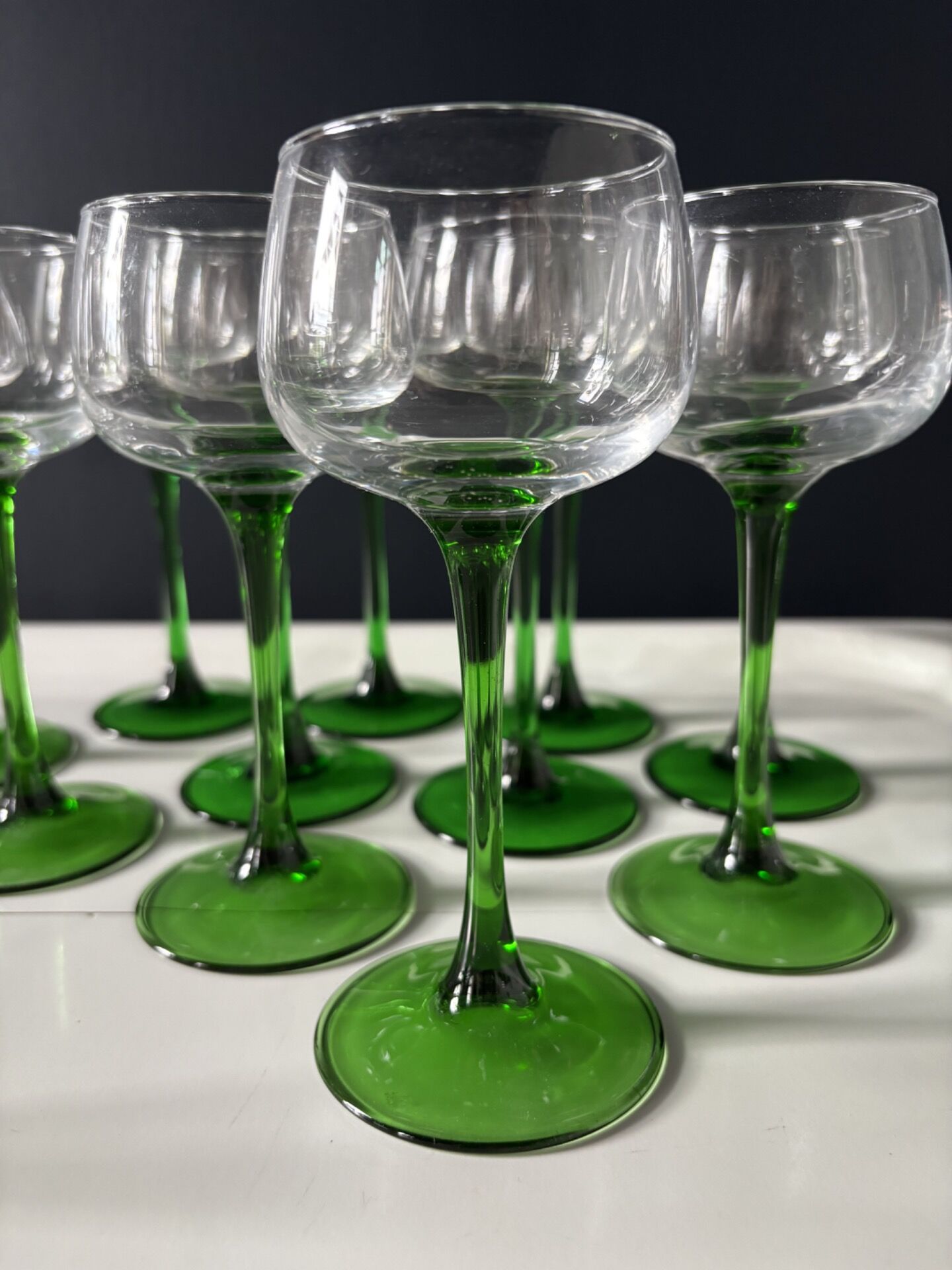 Set of 12 Alsatian Roemer glasses with green stems.