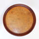 Round Art Deco side table in wood with curved legs and brass feet.