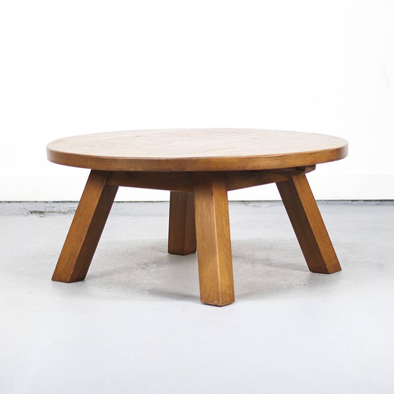 Large rustic vintage coffee table in a round brutalist style.